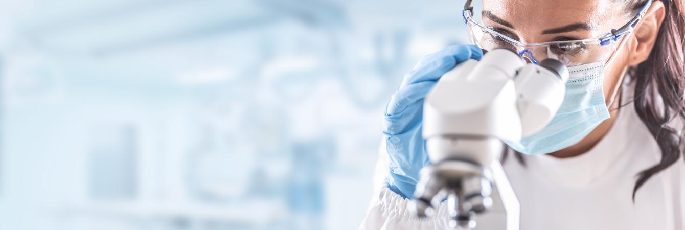 Woman looking through microscope